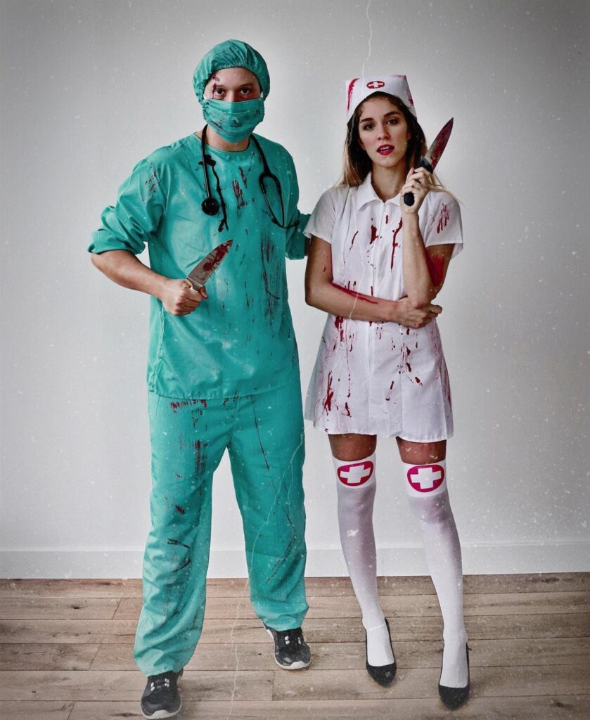 Man in teal scrubs and woman in white nurse dress holding bloody knives.