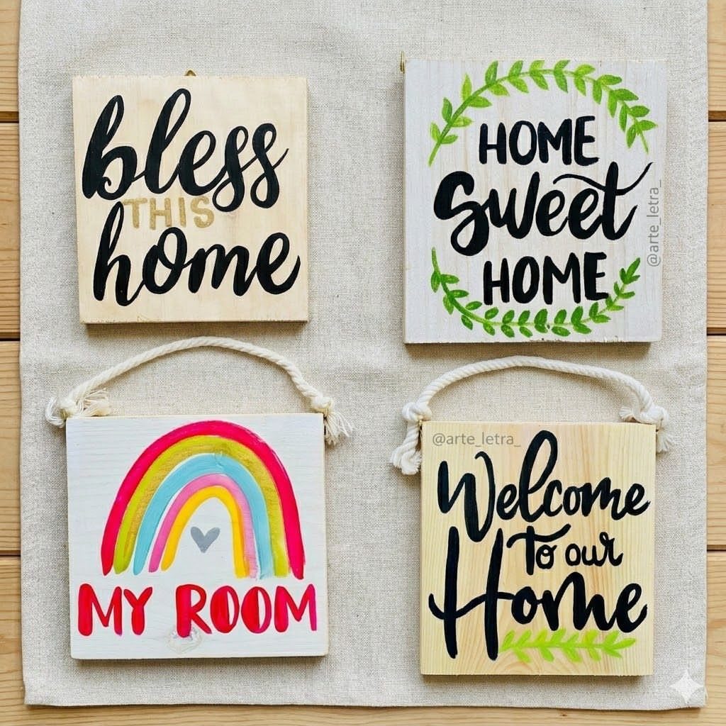 Four hand-painted wooden wall plaques with welcoming home messages and a rainbow design.