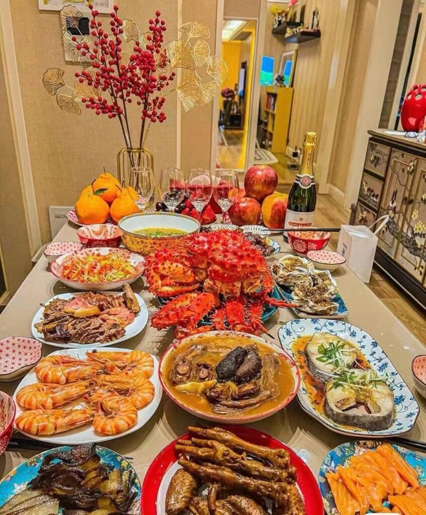 Lavish dinner spread with lobster, shrimp, and champagne on a decorated home table.